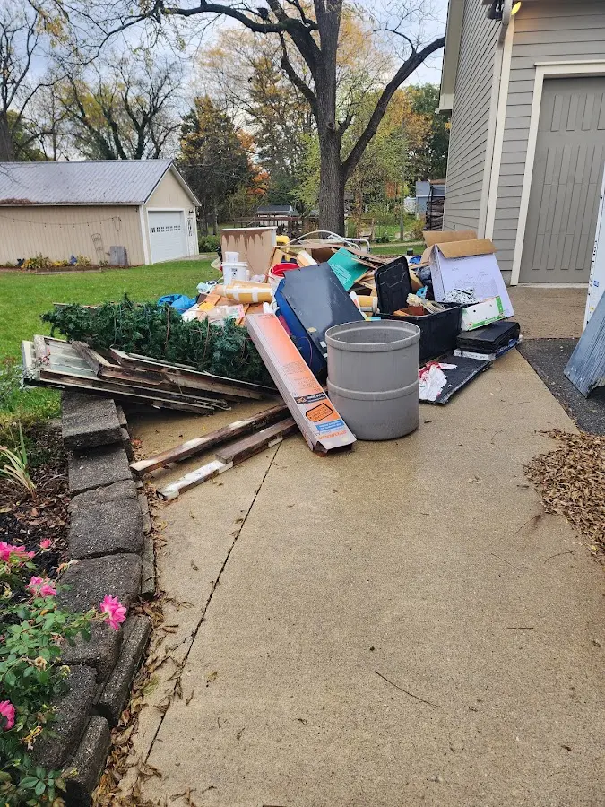 Dumpster being loaded with debris for Estate Cleanout Dumpster Rental in Fountain Inn